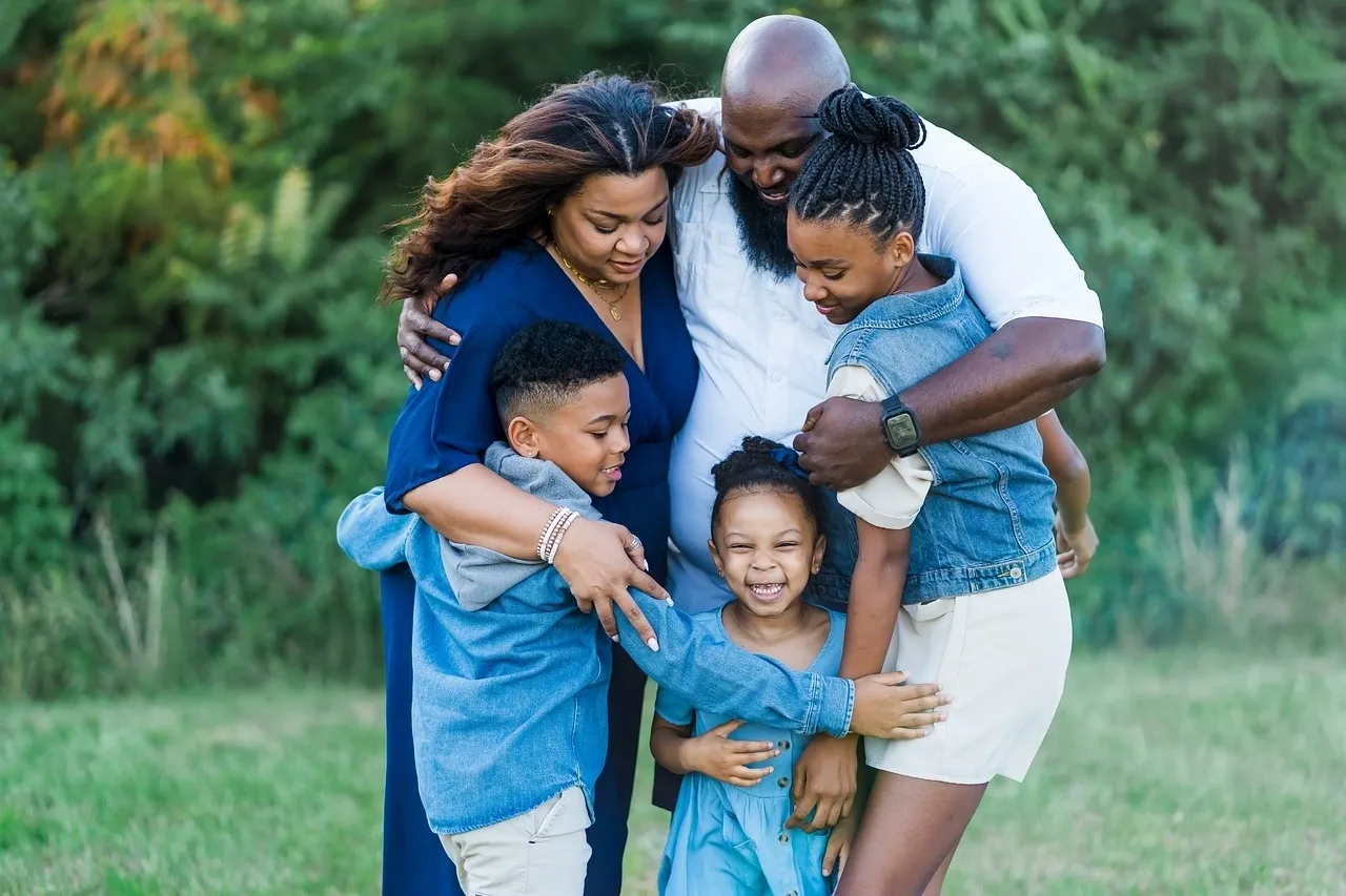 A family of five is posing for the camera.