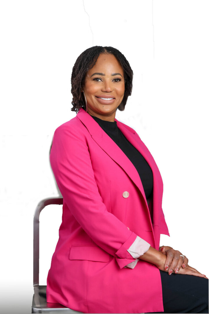 Portrait of person in magenta blazer, hoop earrings